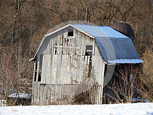 Old sagging wood barn gambrel roof in Fingerlakes NYS photo
