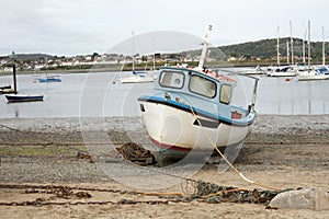 A old wood boat park alone on the sand beach