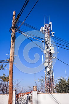 The old wood cable post and the modern host cellular antenna tow