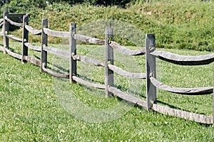 Old wood fence on green grass background