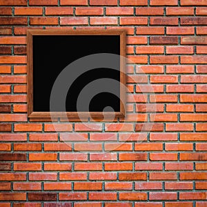Old wood frame on red brick wall background