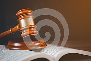 Old wood Judge Hammer with law book on the table wood background, Used for adjudication and Justice