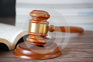 Old wood Judge hammer with law Book on the table wood background, Used for adjudication and Justice