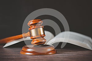 Old wood Judge hammer with law book on the table wood background, Used for adjudication and Justice