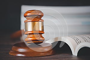 Old wood Judge Hammer with Law Book on the table wood background, Used for adjudication and Justice