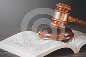 Old wood Judge Hammer with Law Book on the table wood background, Used for adjudication and Justice