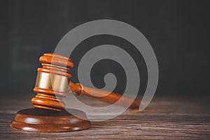 Old wood Judge hammer with law book on the table wood background, Used for adjudication and Justice