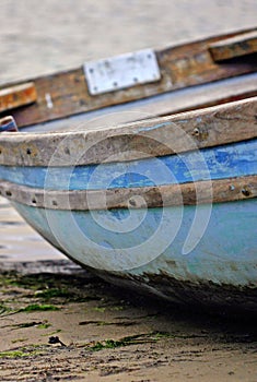 Old wood row boated moored on lake shore