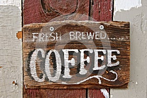 Old wood sign advertising fresh brewed coffee