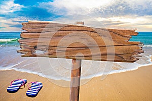 Old wood sign on beach