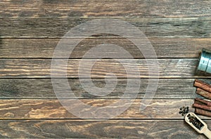 Old wood table with cinnamon, star anise, peppercorns. Background of wooden texture. Close-up pattern