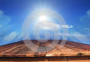 Old wood table and sun shine on blue sky