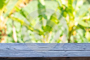 Old Wood table top on blur background of the garden and tree