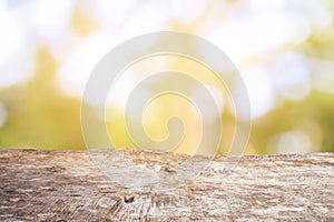 Old wood table top with sunlight bokeh and blur background