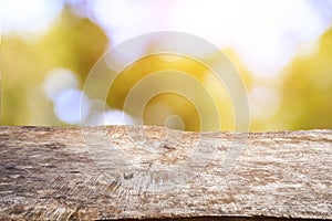 Old wood table top with sunlight bokeh and blur background