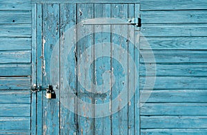 Old Wood texture Gate with Locked, Garage Door with Padlock, Rustic Blue Wooden wall with metal hinges,Barn entrance with sea blue