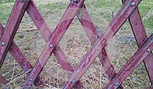 Old wood texture. The old red wooden fence is made of weathered boards crosswise