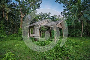 Old wooden abandoned cottage against sky