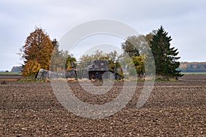 Old wooden abandoned farmstead in the middle of the field in Lithuania