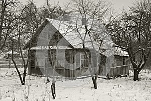 Old wooden abandoned house in russian viillage, monochrome image in retro style