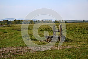 An old wooden abandoned well on the edge of the village.