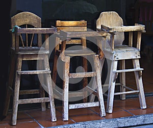 Old wooden baby highchairs in the restaurant
