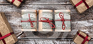 Old wooden background, American money, gifts. Top view. Different values. Space for text