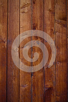 Old wooden background, close-up. Brown vertical boards. Facing the exterior walls of the house