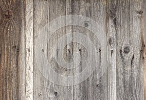 Old wooden background with cracks and nails, darkened and weathered boards