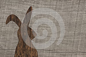 Old wooden background with an easter bunny for decoration items.