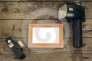 Old wooden background with isolated place under the photo and retro camera elements