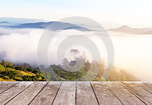 Old wooden balcony terrace on viewpoint high tropical rainforest mountain with white fog in early morning