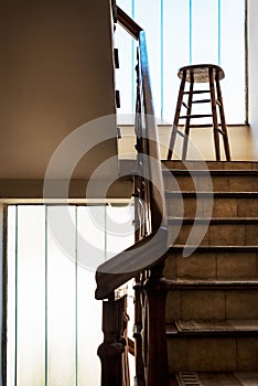 Old wooden Bar Stool in a Wooden Staircase with Handrailing in an Old house