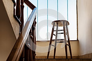 Old wooden Bar Stool in a Wooden Staircase with Handrailing in an Old house