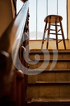 Old wooden Bar Stool in a Wooden Staircase with Handrailing in an Old house