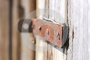 Old wooden barn door with steel hinges