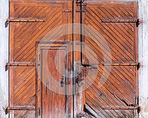 Old wooden barn doors on concrete wall
