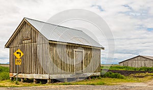 An old wooden barn in a farm in overcast day in Canada