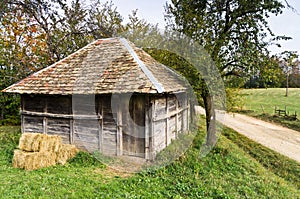 Old wooden barn by a gravel mountain road, Bobija mountain