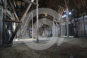 Old wooden barn with light shining through wooden boards