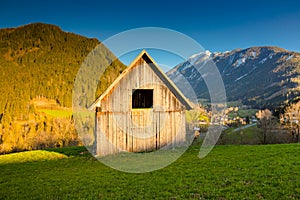 Old wooden barn used by farmers in Schladming, Austria, Styria, Austrian Tyrol, and mountains in the background