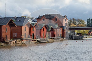 Old wooden barns on the embankment of the Porvoonjoki river photo