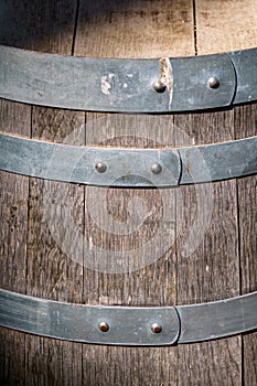 Old wooden barrel with gray metal circles