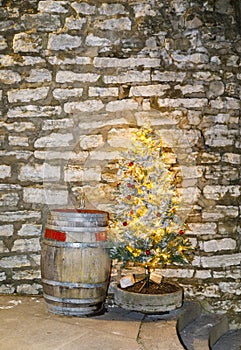 Old wooden barrel and illuminated Christmas tree