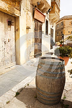 Old wooden barrel on narrow street Mdina, Malta