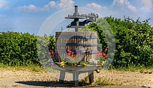 Old wooden barrel wine press, vineyard, Alsatian Wine Route in Riquewihr, France