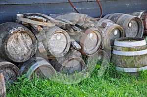 Old wooden barrels or kegs on the wall of a barn