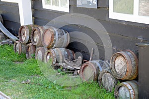 Old wooden barrels or kegs on the wall of a barn