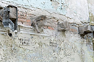 Old wooden beams in ruined brick wall of abandoned building