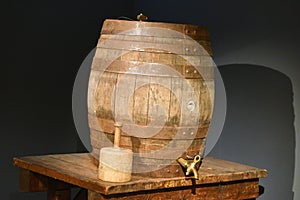 An old wooden beer keg with a mallet